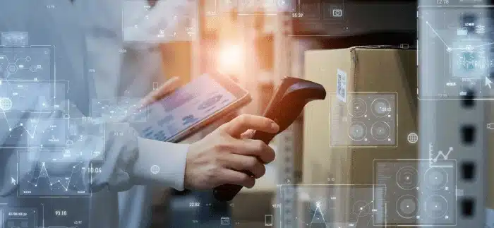 Professional using mobile device with digital warehouse management analytics overlay display