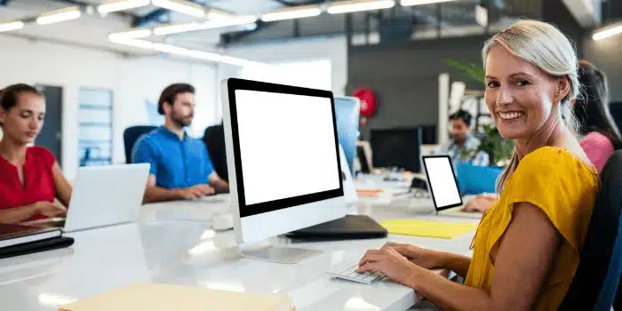 Professional woman using computer in modern office workspace for performance review