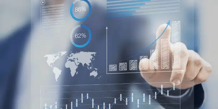Business professional analyzing supply chain data with digital charts and global metrics