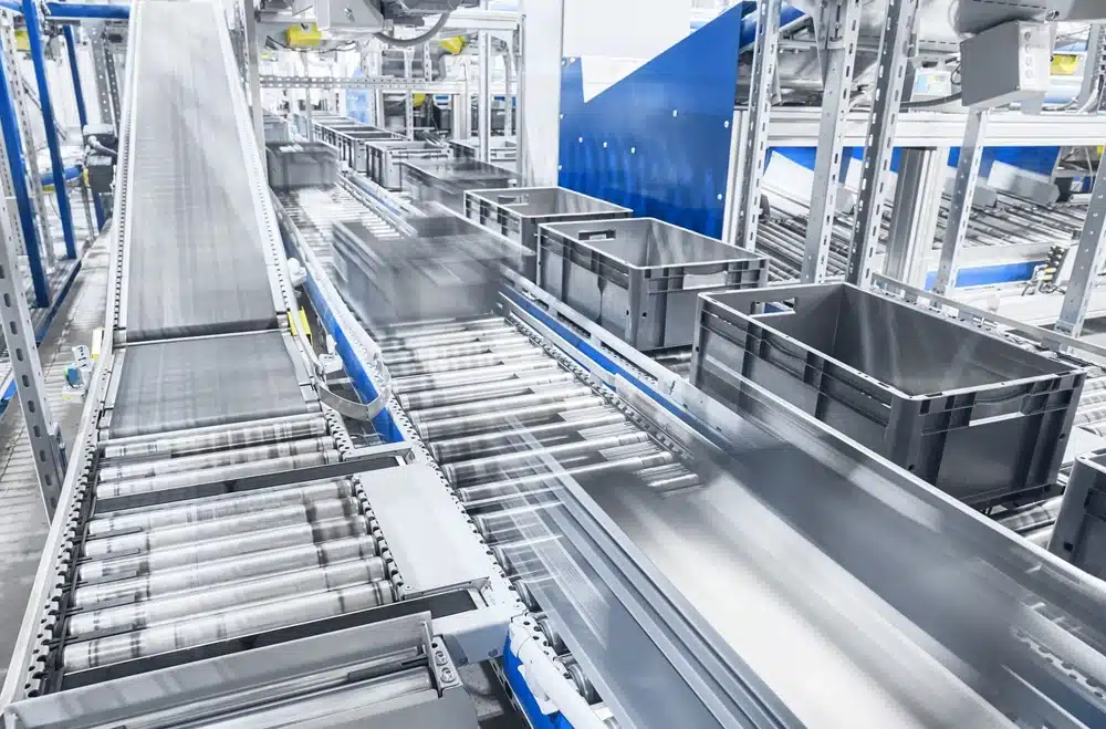 Automated warehouse conveyor system with gray storage bins for shipping and receiving operations