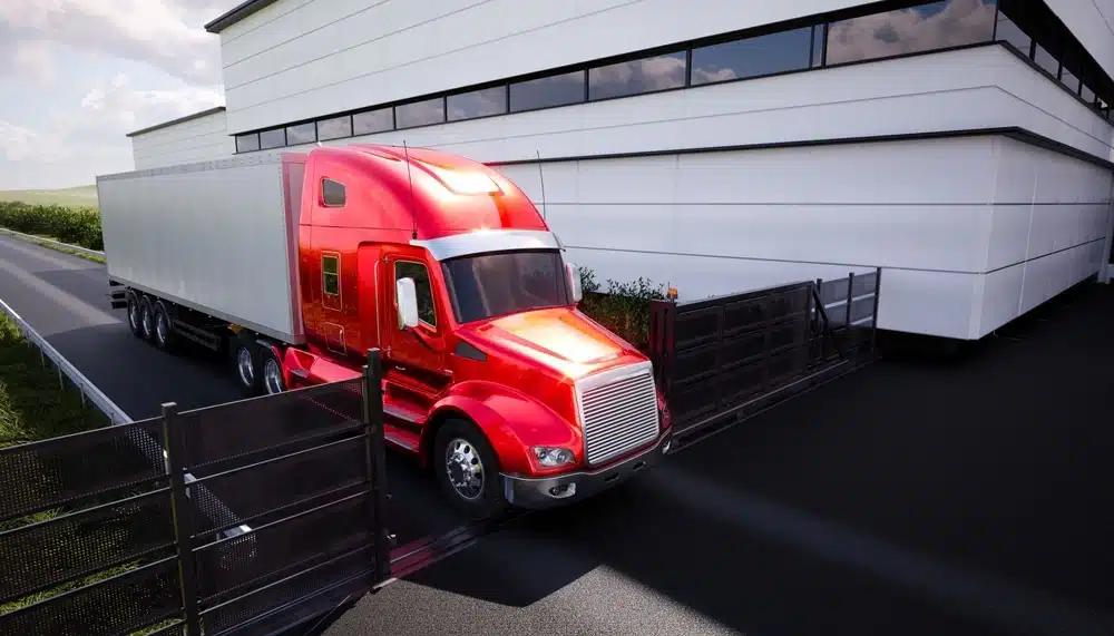 Red semi-truck with white trailer at modern warehouse loading dock facility