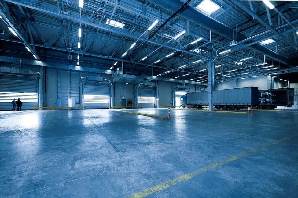 Modern warehouse interior with loading docks and truck for cross docking operations