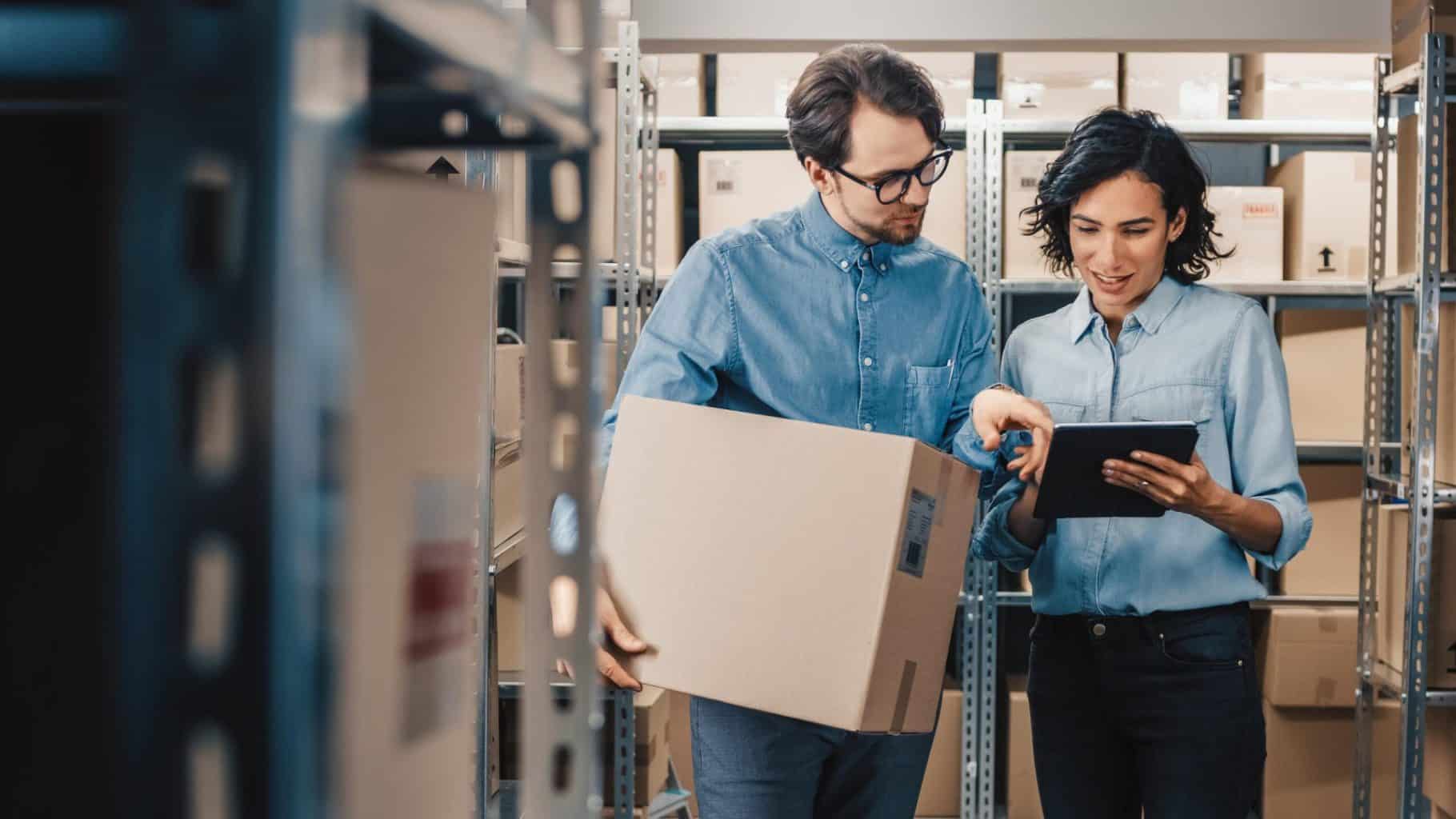 two workers pointing at tablet