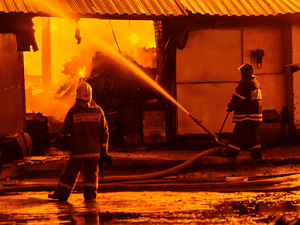 firefighters putting out warehouse fire
