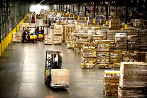 forklifts moving pallets in a warehouse