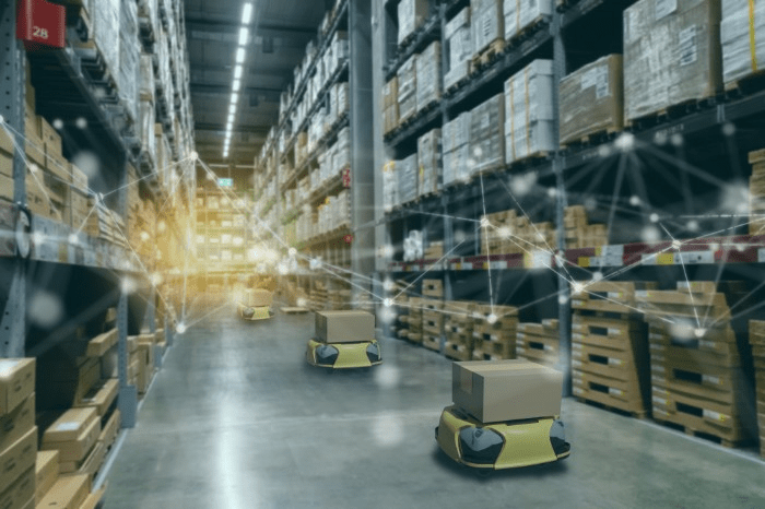 warehouse aisle with robots moving boxes