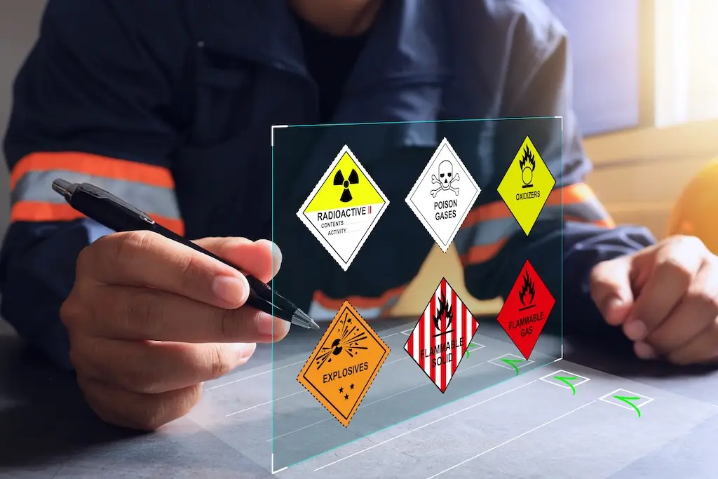 worker at desk with warehouse safety hazardous material symbols
