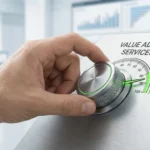 Hand turning dial to increase value added services gauge to 100 percent