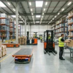 Workers using barcode scanners and AGVs in a well-stocked, bustling warehouse.