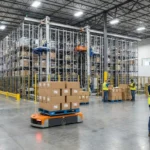 Modern warehouse interior with automated systems and workers scanning products for inventory turnover management.